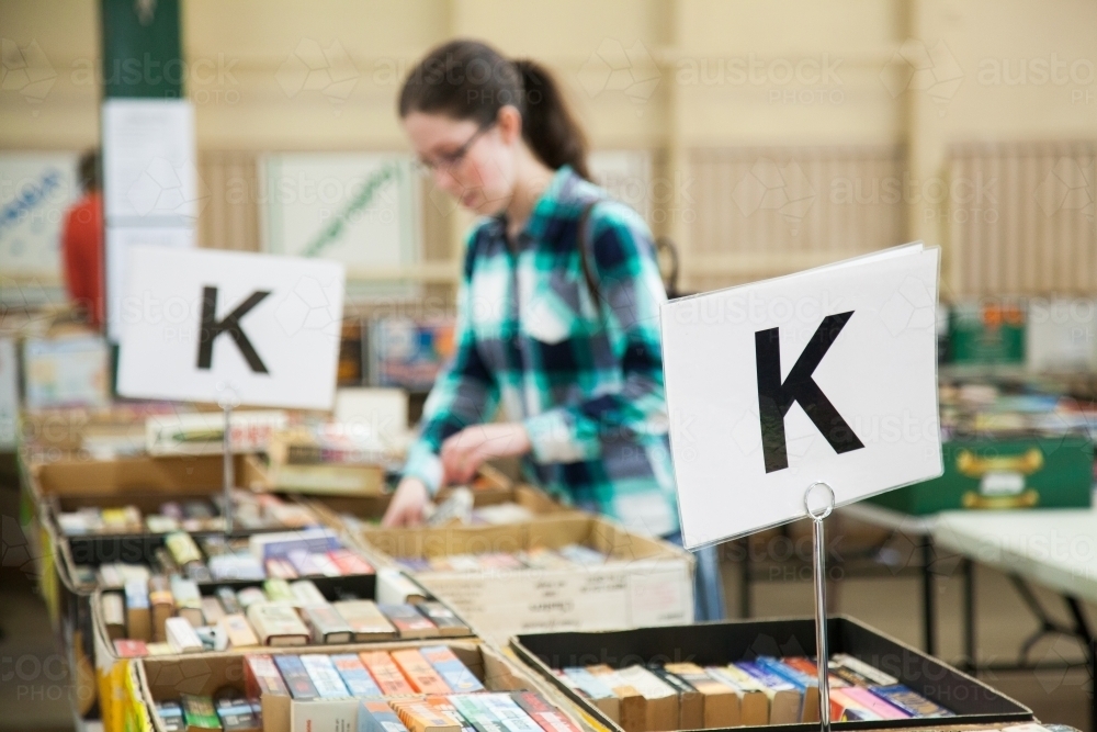 People looking through books at a book fair sale - Australian Stock Image