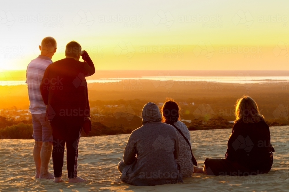 People observing sunset at Carlo Sandblow, Rainbow Beach. - Australian Stock Image