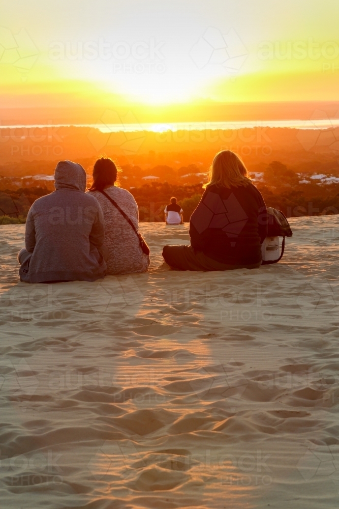 People observing sunset at Carlo Sandblow, Rainbow Beach. - Australian Stock Image