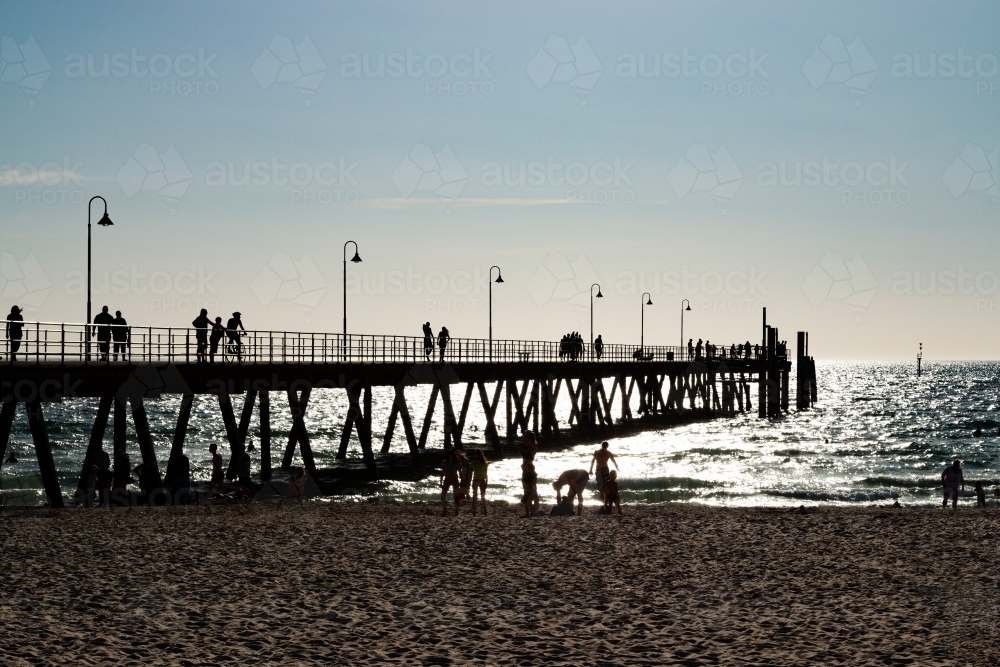 people on beach and jetty - Australian Stock Image