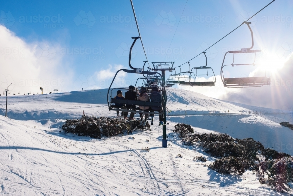 People on chairlift at ski resort - Australian Stock Image