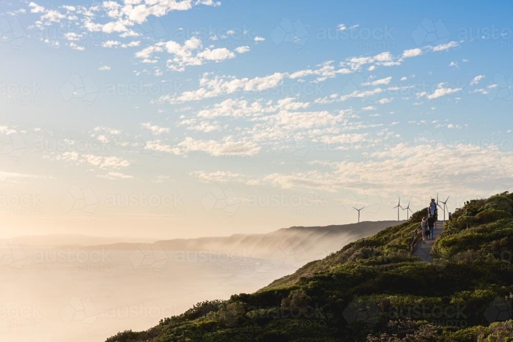 People on walking track at coastal windfarm - Australian Stock Image