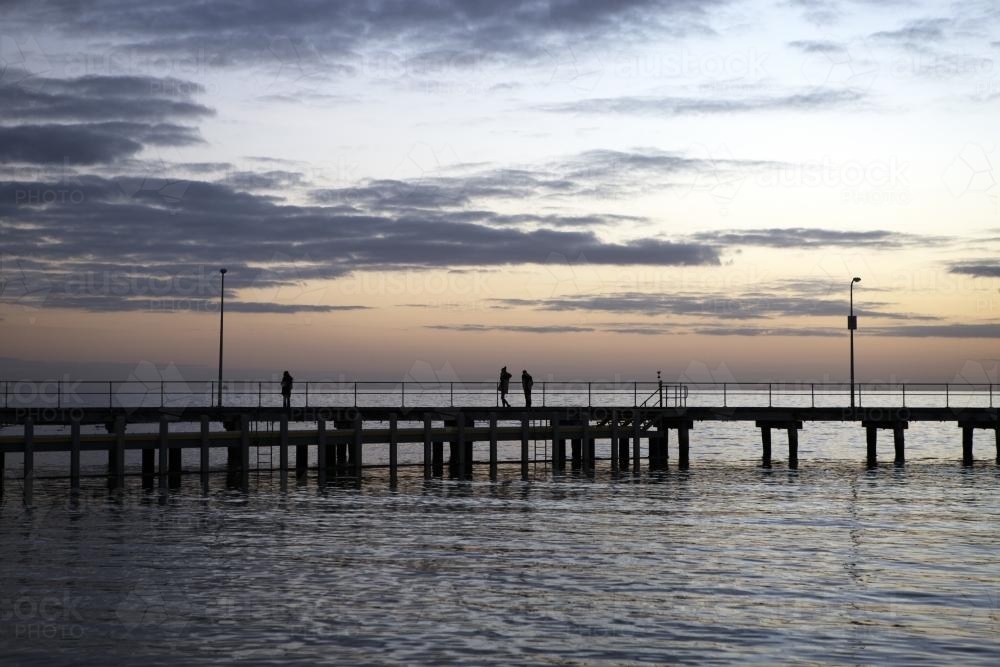People on wharf at sunset - Australian Stock Image