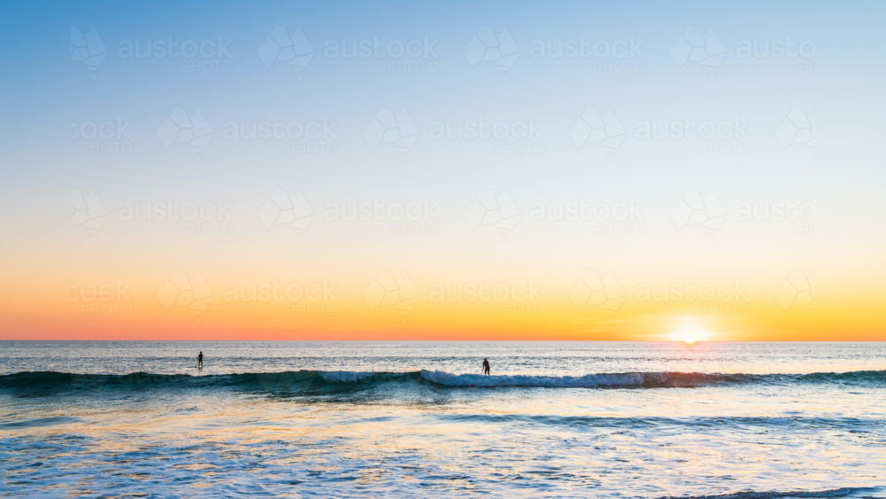 People paddleboarding at Southport beach, Port Noarlunga, South Australia - Australian Stock Image