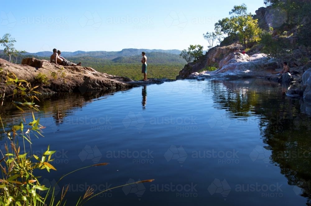 People relaxing by the water at Gunlom Lookout Kakadu - Australian Stock Image