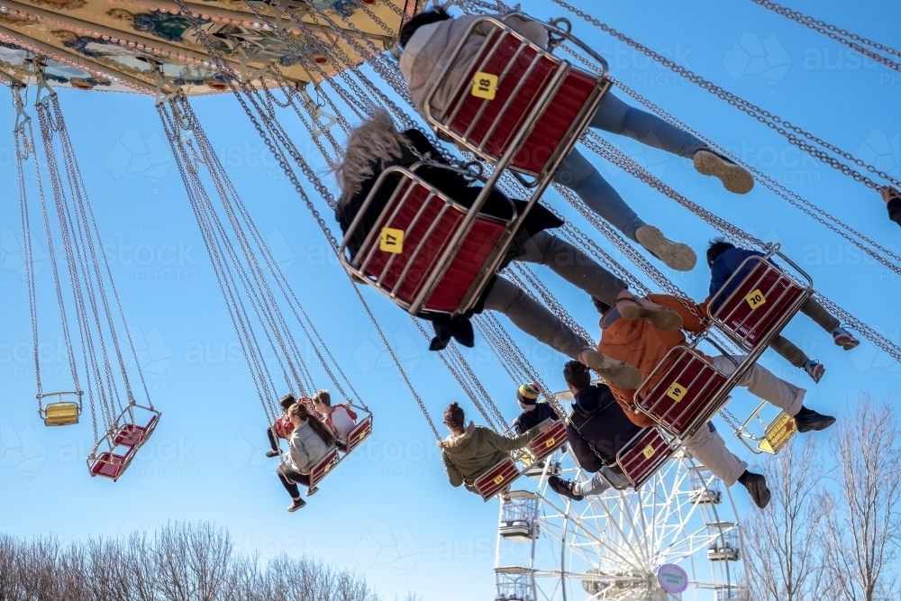 People riding a swing chair ride - Australian Stock Image