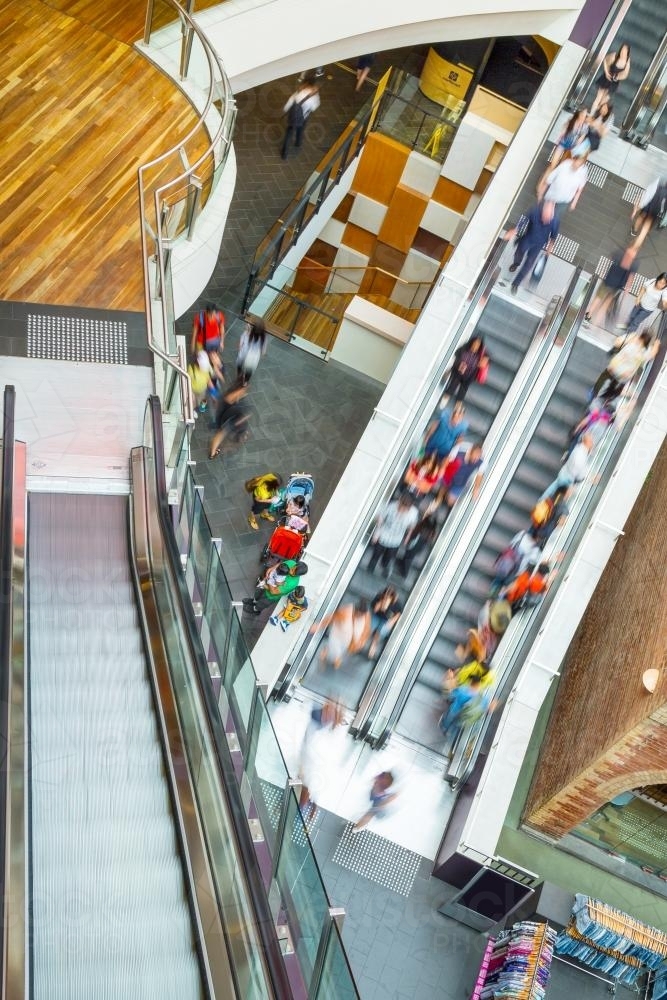 People riding on an escalator - Australian Stock Image