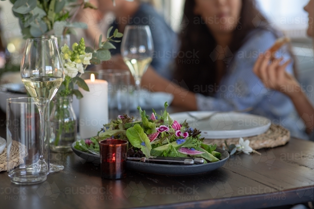 People Sharing Healthy Meal at Rustic Table Setting - Australian Stock Image