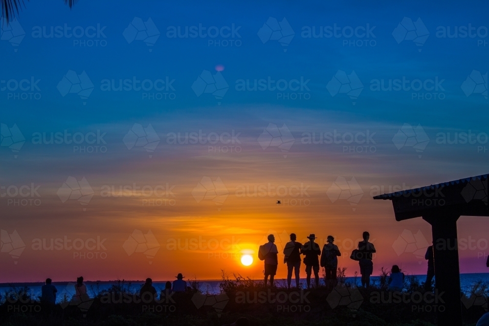 People silhouetted by the sunset - Australian Stock Image