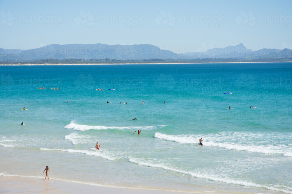 People swimming and surfing at Byron Bay - Australian Stock Image