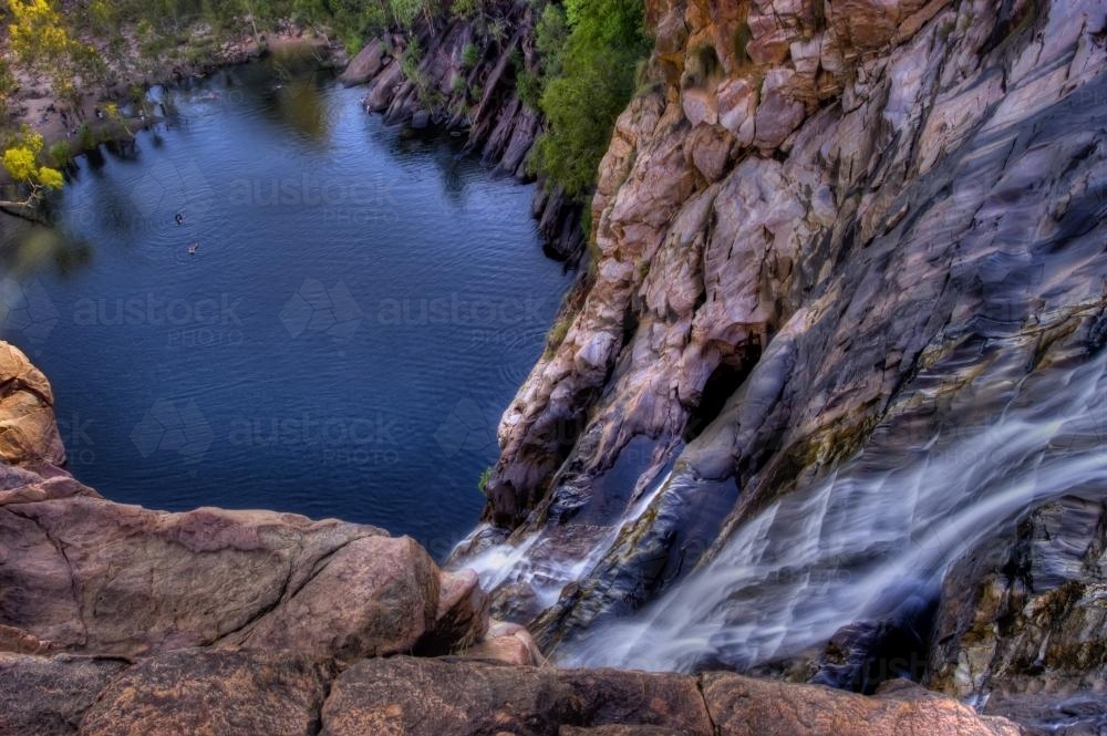 People swimming below Gunlom Falls Kakadu - Australian Stock Image