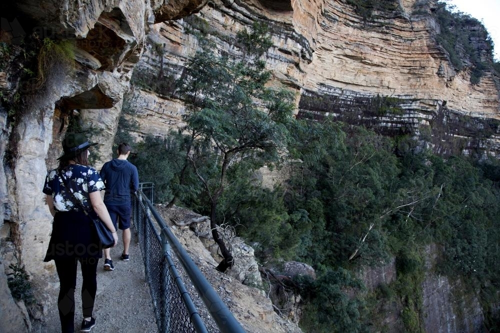 People walking along path by cliff - Australian Stock Image