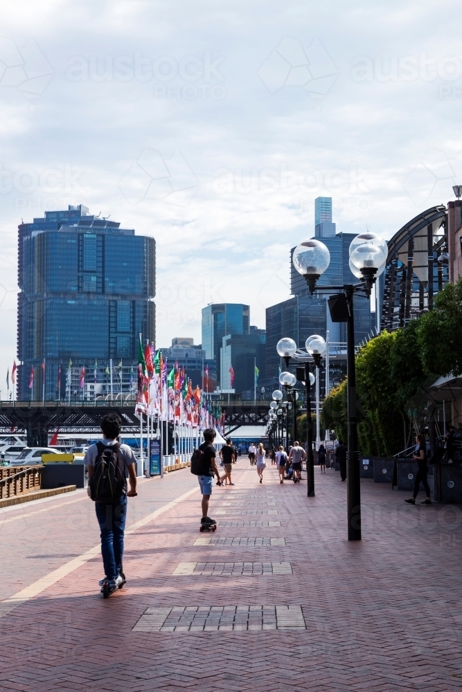 people walking along waterfront cafe strip, vertical - Australian Stock Image