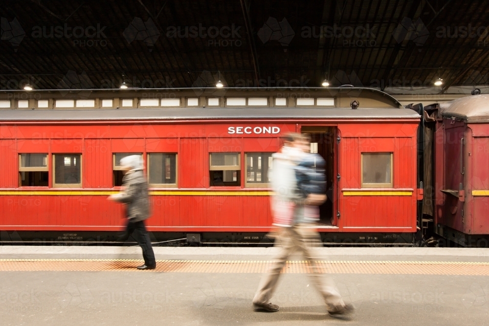 People walking past heritage carriages on a platform - Australian Stock Image