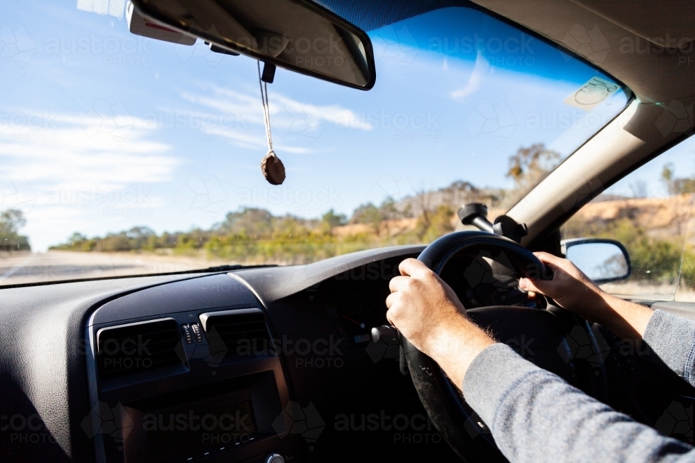 Person driving car on highway in daylight - Australian Stock Image