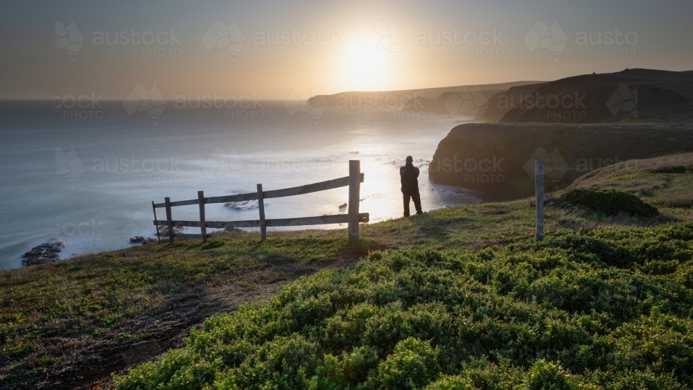 Person enjoying view from Cairn Beach, Victoria - Australian Stock Image