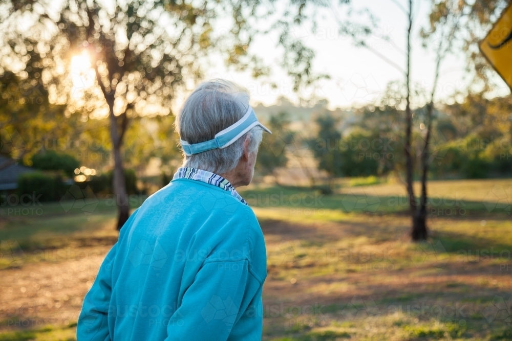 Person hiking through park in the early morning - Australian Stock Image
