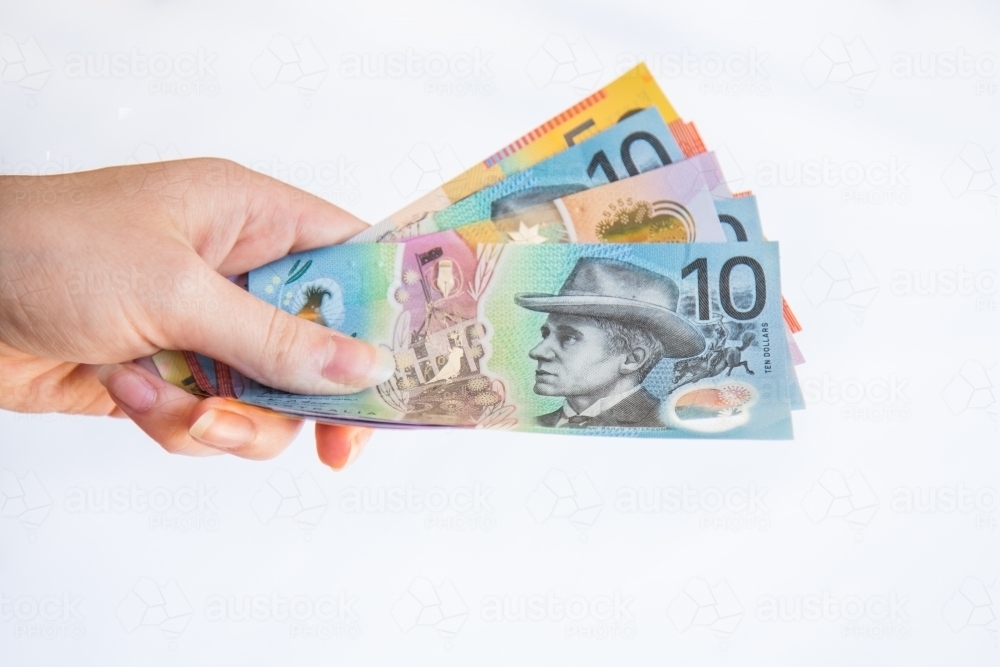 Image of Person holding cash australian currency Austockphoto