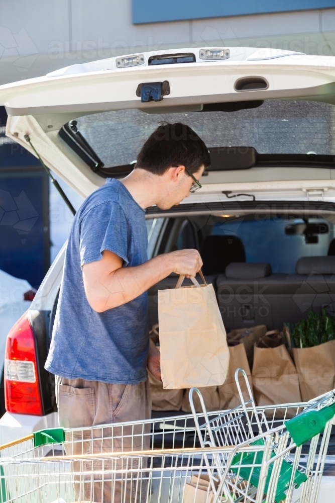 Person packing shopping into car from click and collect - Australian Stock Image
