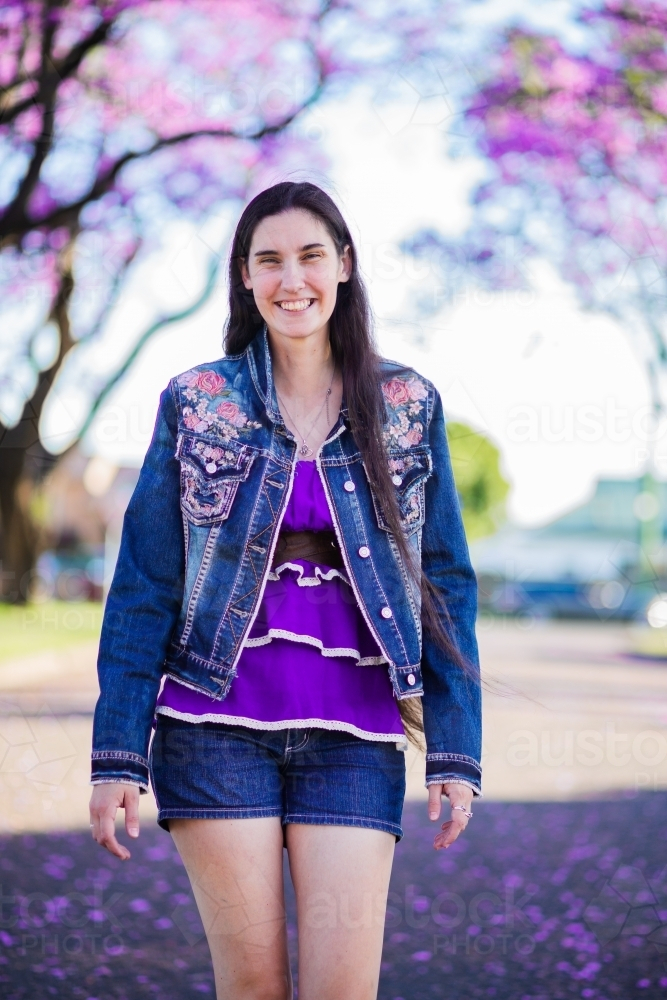 Person Outside Spring Image of Person walking outside in spring smiling - Austockphoto