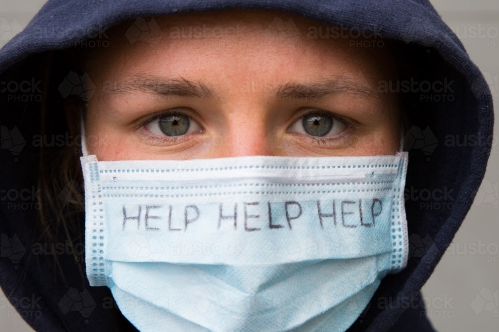Person Wearing Face Mask with the Word HELP - Australian Stock Image