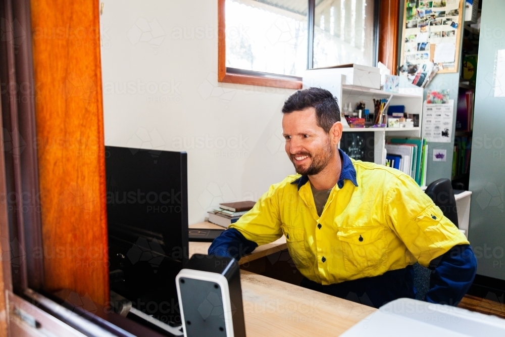 Person working on computer in home office - Australian Stock Image