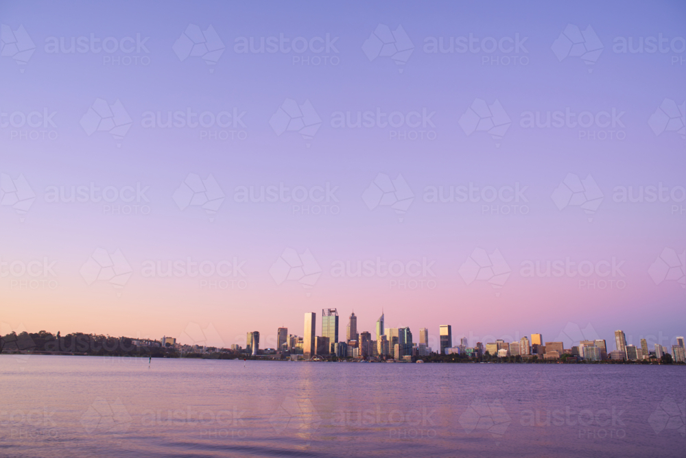 Perth City skyline at dusk across the Swan River - Australian Stock Image