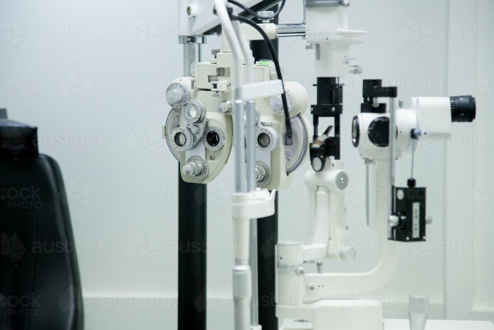 Phoropter and other eye testing machines in optometrist's room - Australian Stock Image