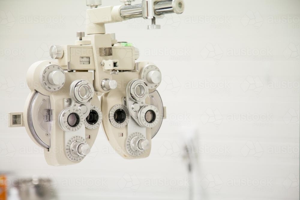 Image of Phoropter, eye doctor machine in a white room Austockphoto