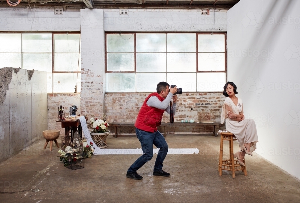 Photographer and model at styled wedding photoshoot - Australian Stock Image