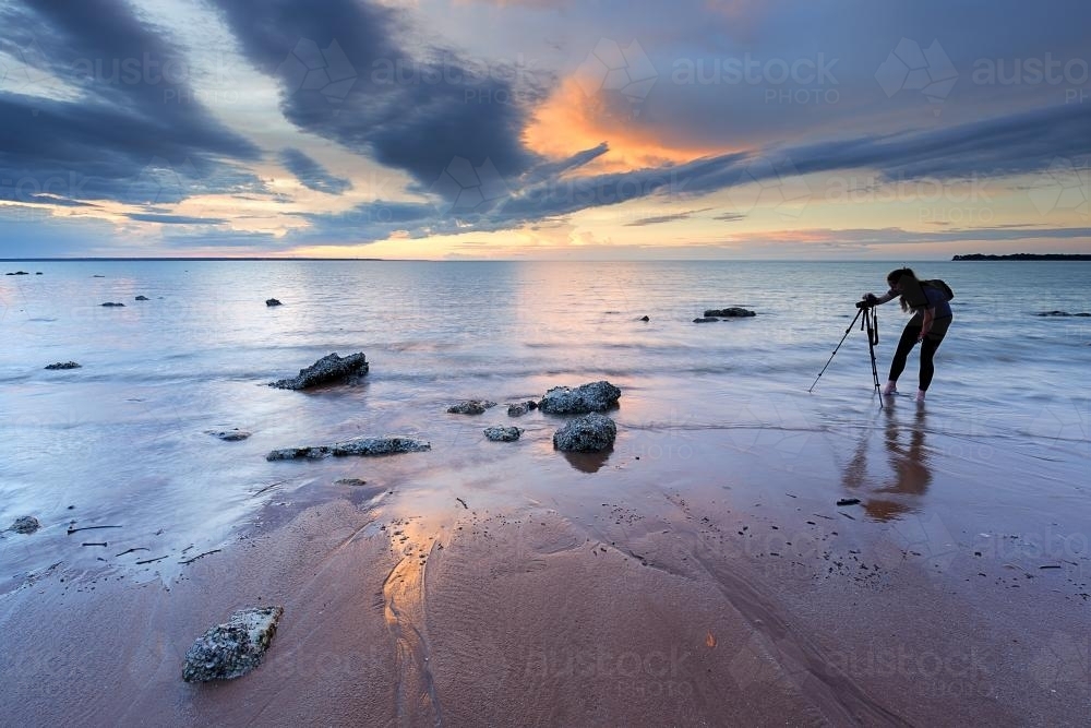 Photographer at sunset on the beach - Australian Stock Image