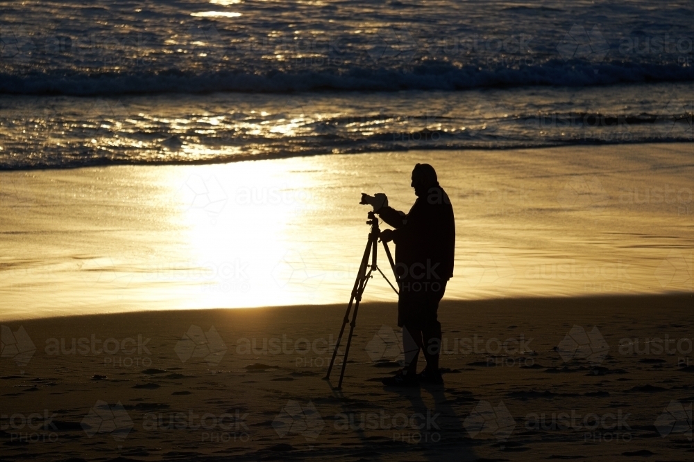 Image of Photographer on a Beach with a Camera and Tripod - Austockphoto
