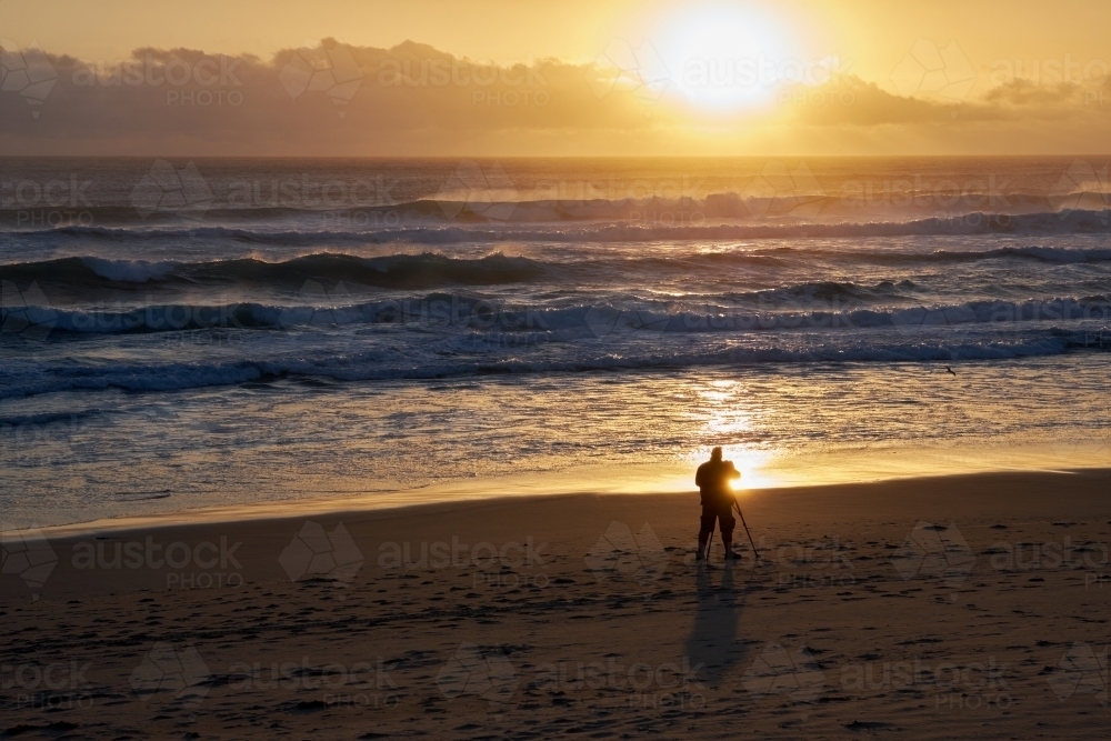 Photographer on a Beach with a Camera on a Tripod - Australian Stock Image