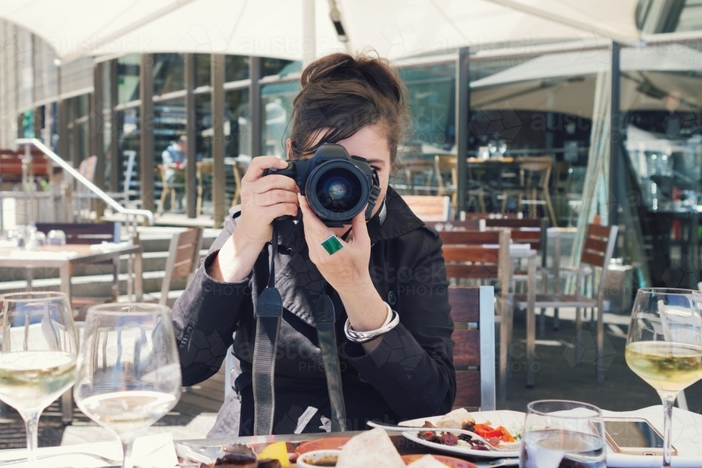 Photographer shooting a portrait of the viewer over lunch - Australian Stock Image