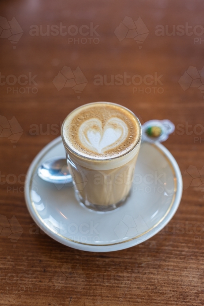 piccolo latte with vintage teaspoon and saucer - Australian Stock Image