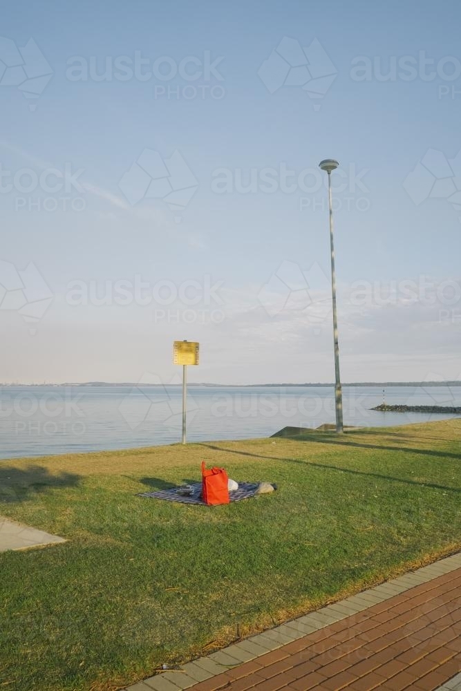 Picnic on the grass looking over the bay - Australian Stock Image