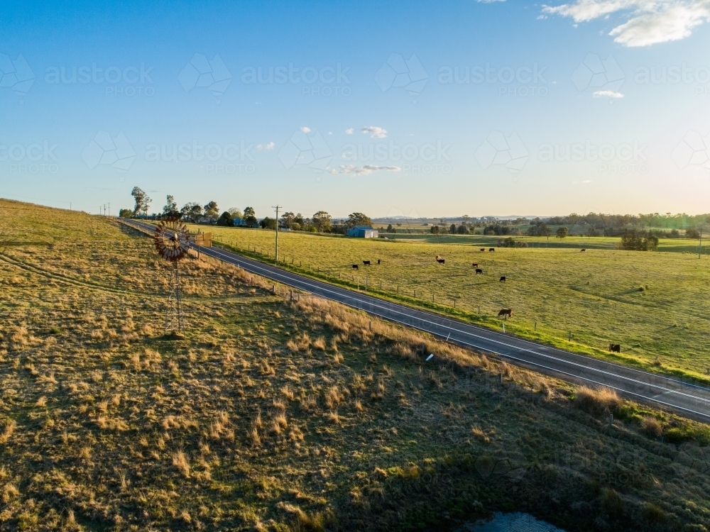 Pretty Paddock Image of Picturesque country scene at sunset of road through farm ...