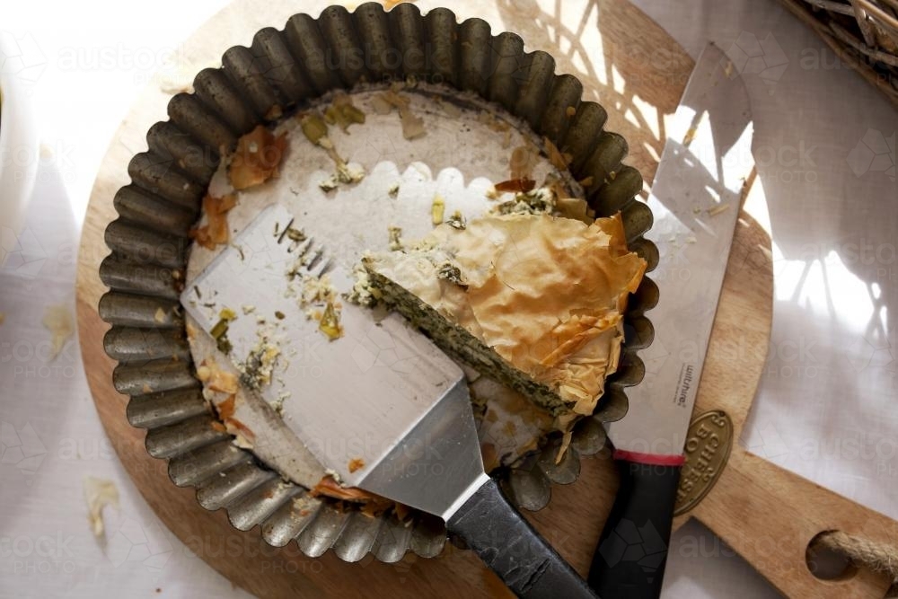 Piece of pie left in tin after serving - Australian Stock Image