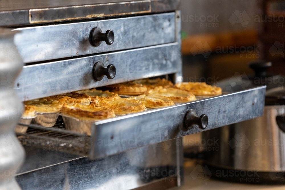 pies in a pie warmer to heat - Australian Stock Image