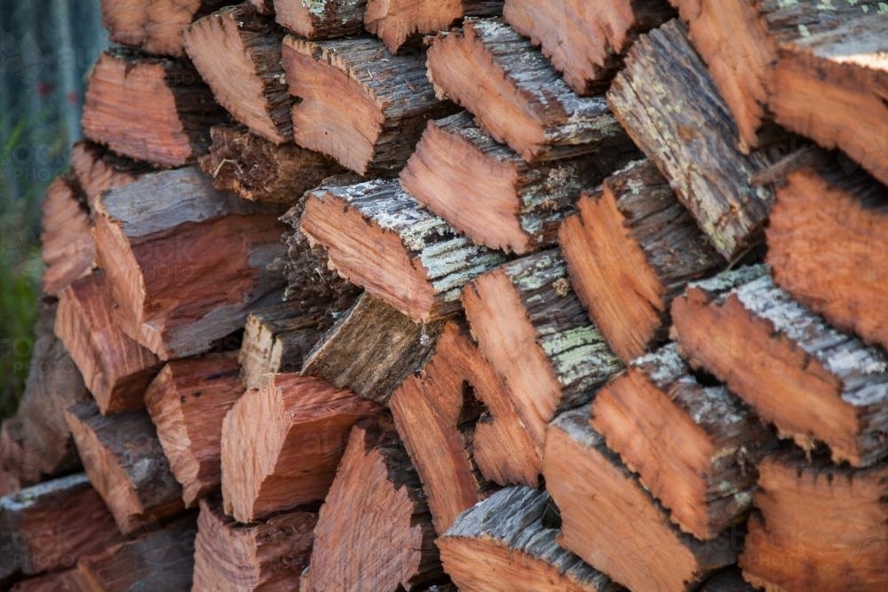 Pile of split wood ready to burn in the fireplace - Australian Stock Image
