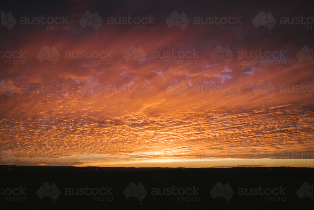 Pink and orange sunset in the Wheatbelt of Western Australia - Australian Stock Image