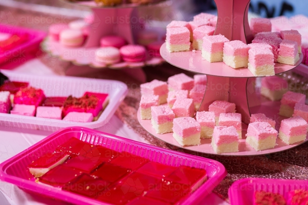 Pink dessert food on pink table at birthday party event - Australian Stock Image