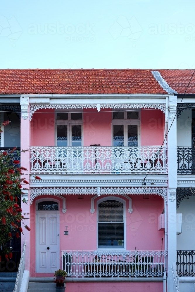 Pink house with white wrought iron décor - Australian Stock Image