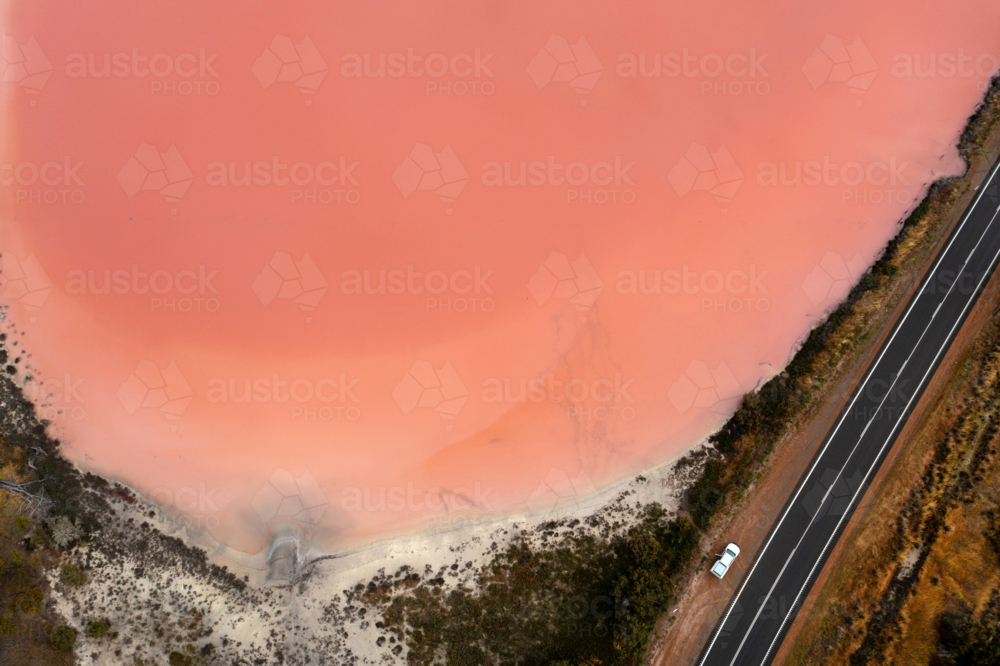Pink Lake and road with car - Australian Stock Image