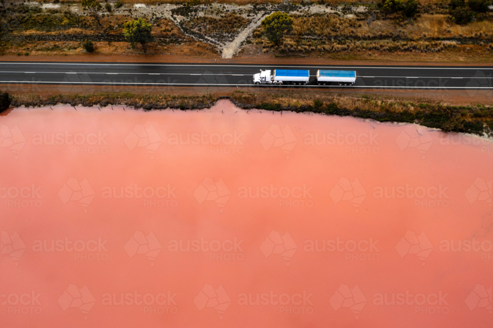 Pink Lake and road with truck - Australian Stock Image