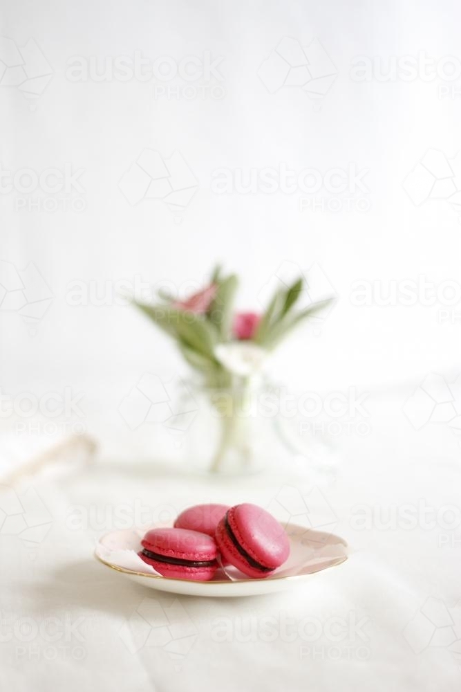 Pink macarons on decorative plate - Australian Stock Image