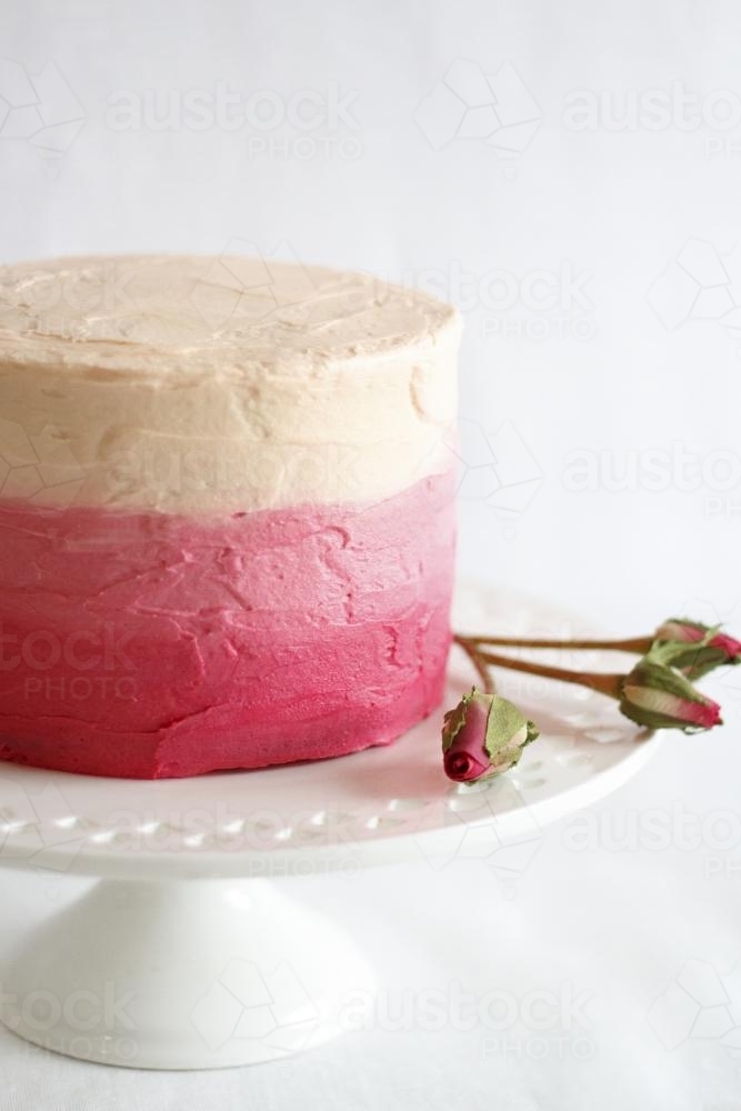 Pink ombre cake on cake stand - Australian Stock Image