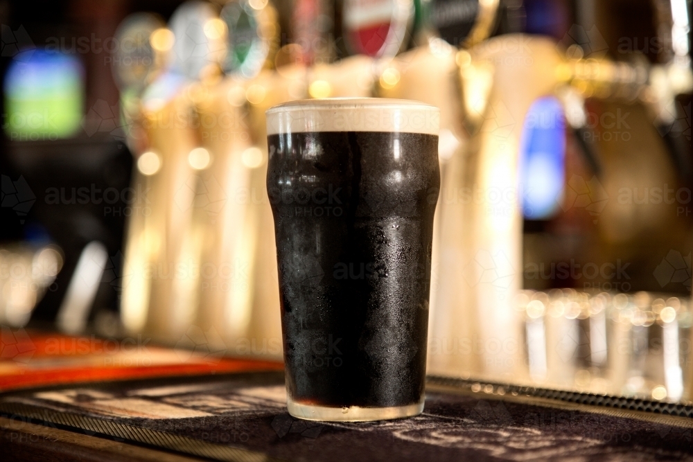 Pint of guinness on a bar - Australian Stock Image