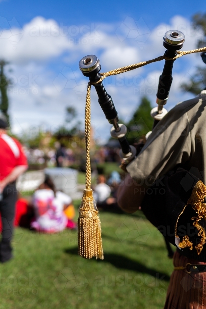 Image of Pipes of bagpipe musician playing during ANZAC Day ceremony