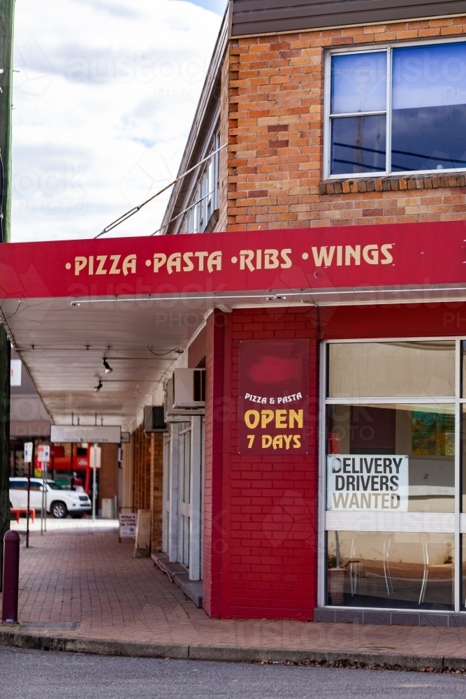 Image of Pizza place sign and shop front on street Austockphoto